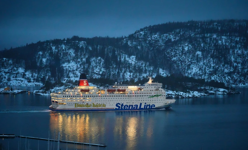 cruise ship sailing in harbor with lighted lights