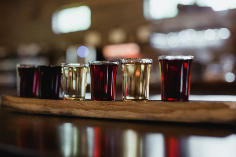 glasses sitting on a wooden counter next to each other