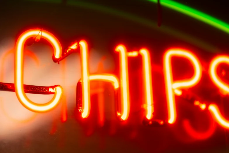 a neon sign with the word chips below it