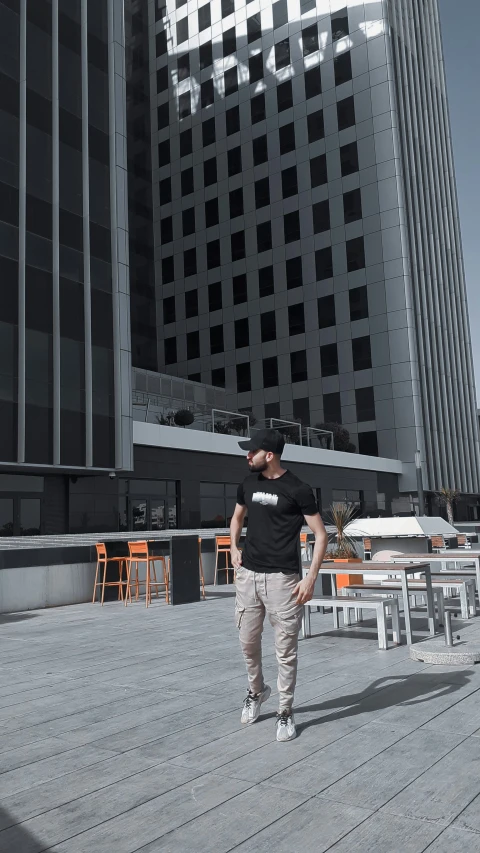 man walking down a street in front of a big building