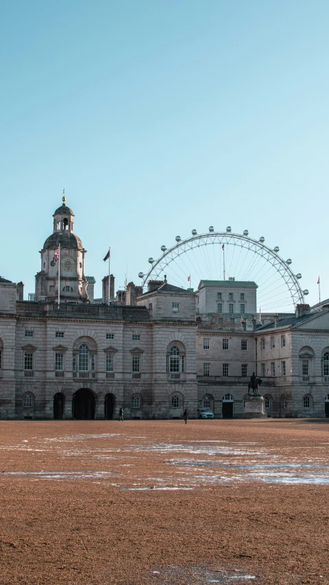 an old mansion with a large ferris wheel in the background