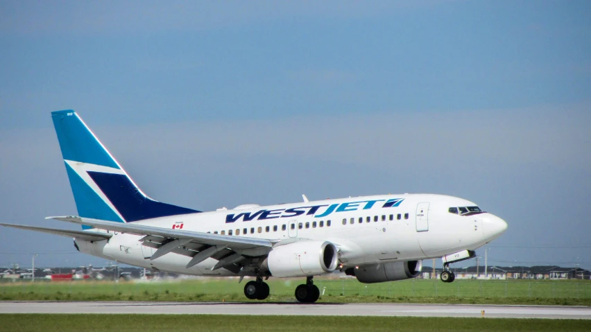 a white airplane is parked on a runway