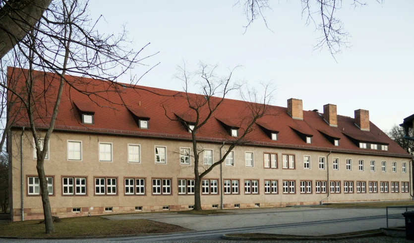 a large building with several windows and some trees