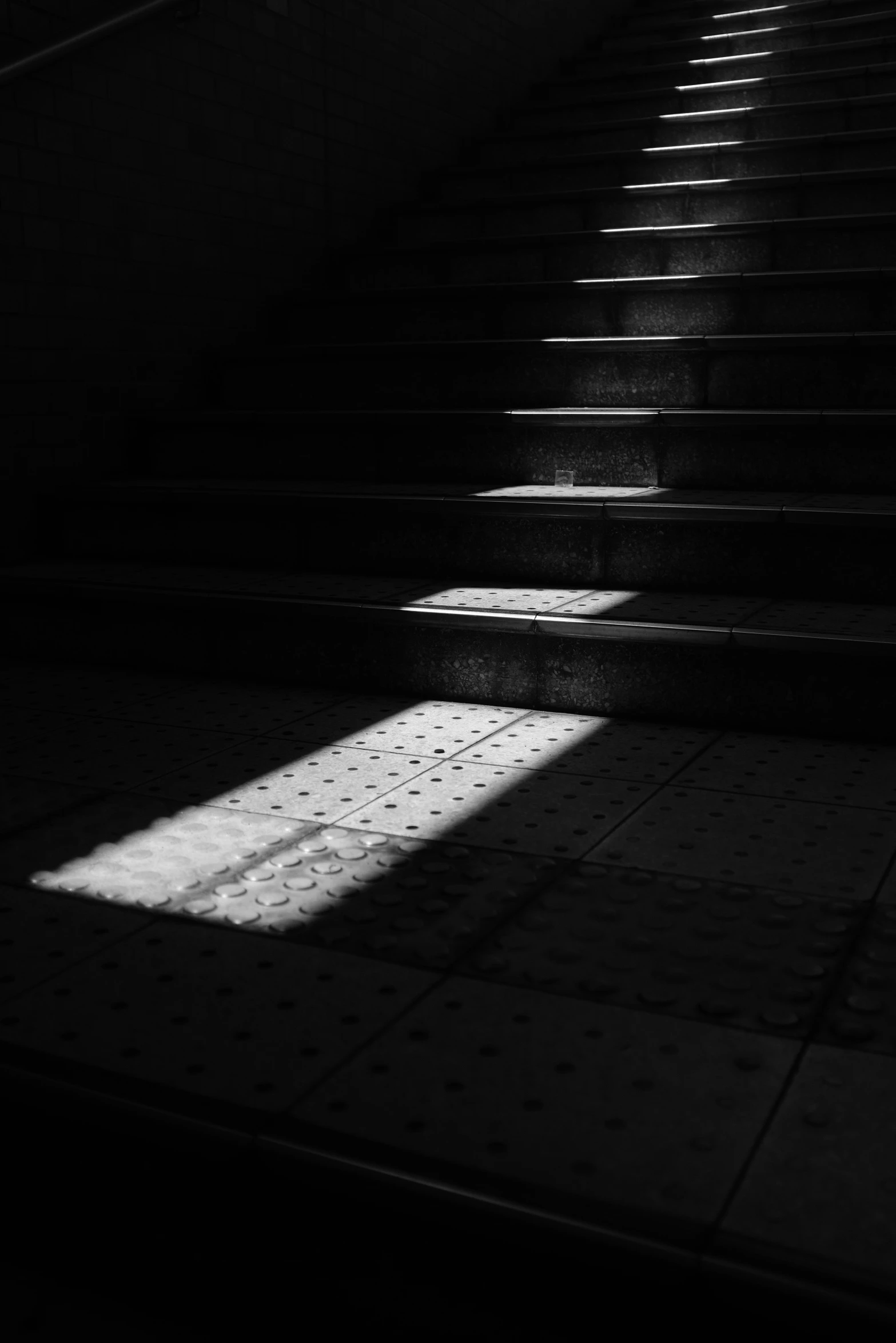 shadows cast onto the floor and stairs on the street