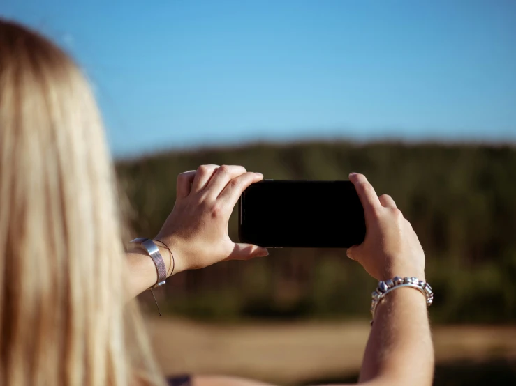 a woman in the middle of taking a picture with her camera