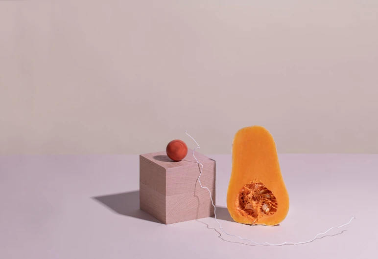 a slice of squash and a fruit peel sitting in front of each other