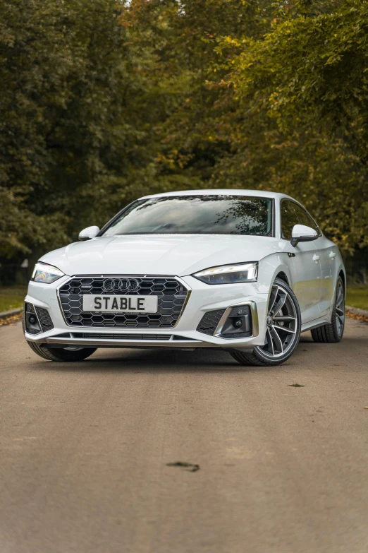 a white sports car is parked in the street