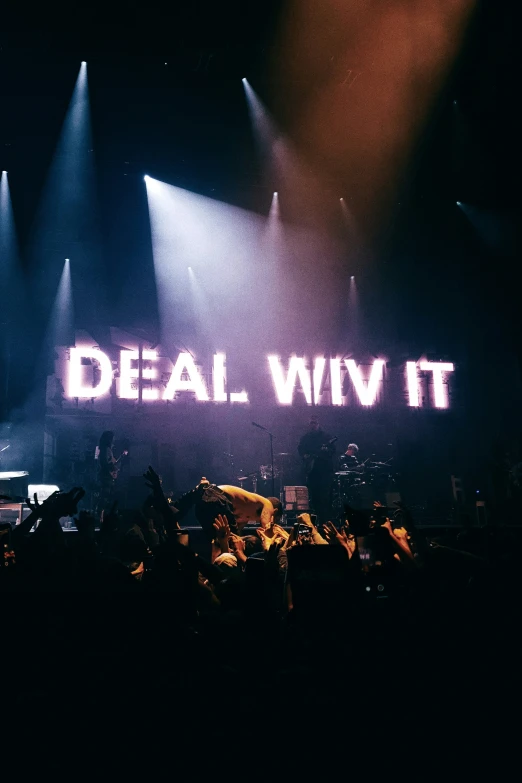 people are standing under light on stage