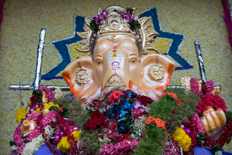 a close up po of a statue of gandeva with flowers