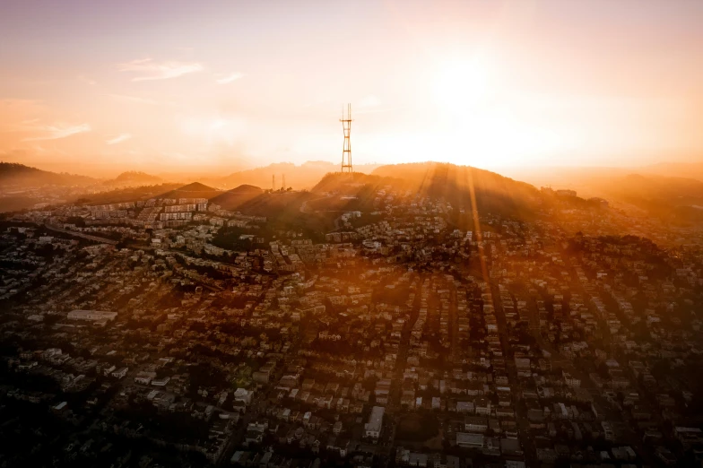 an aerial view of a cityscape with the sun setting