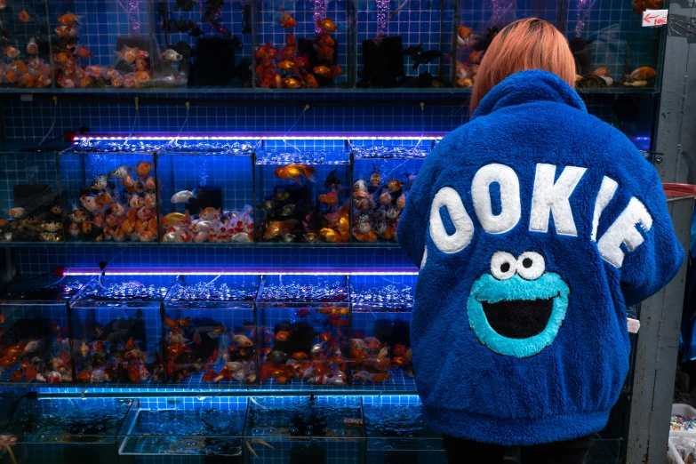 a stuffed cookie mascot jacket on a woman's back