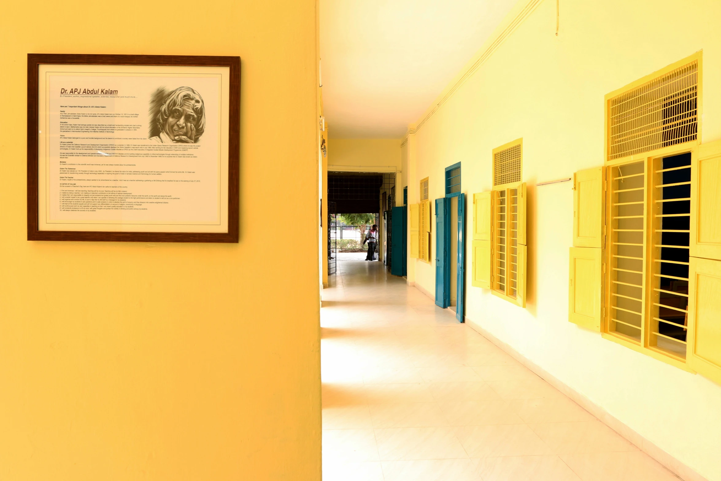 a hallway with signs on the walls and pictures on the wall