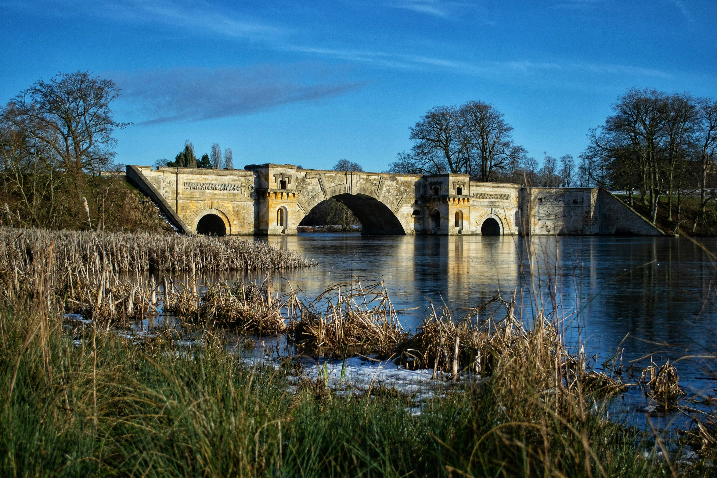 a bridge crosses over a river in the countryside