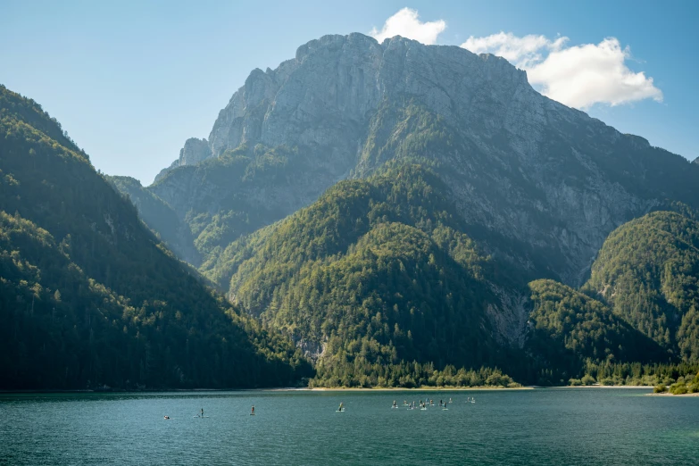 a large lake surrounded by mountains with boats in it