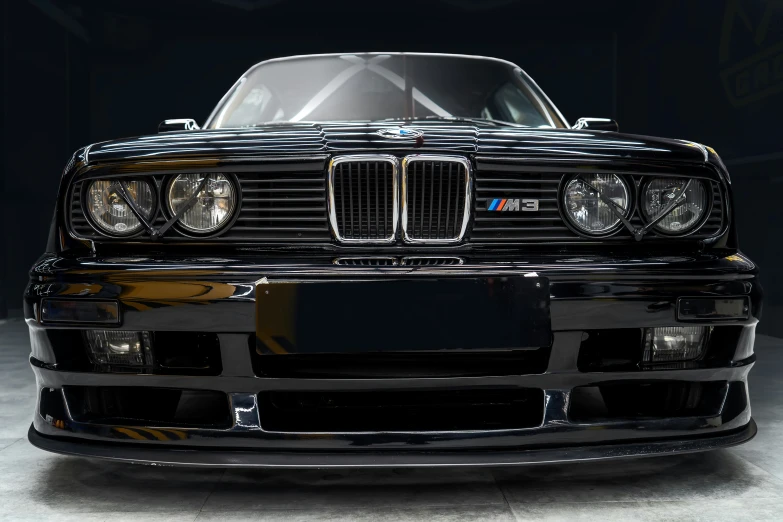 a black sports car parked inside a garage