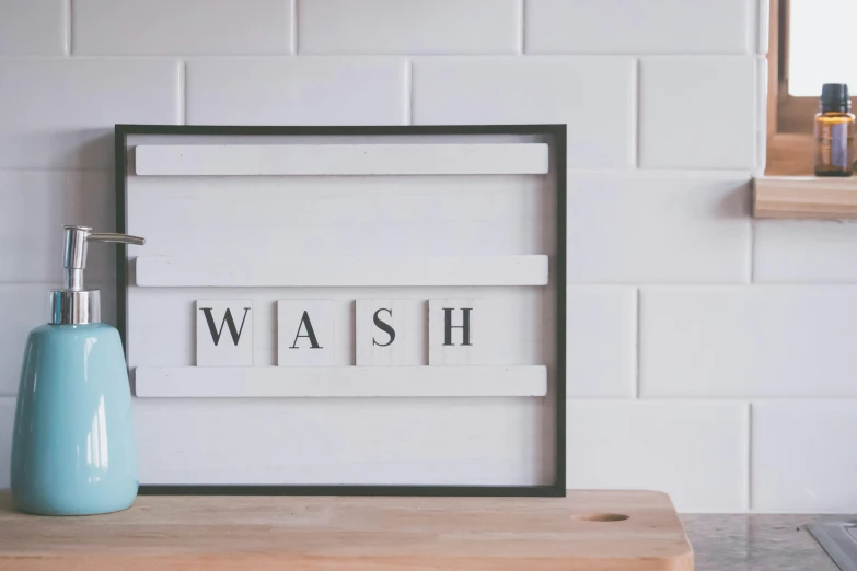 the word wash in multiple cursive letters is above the letter e
