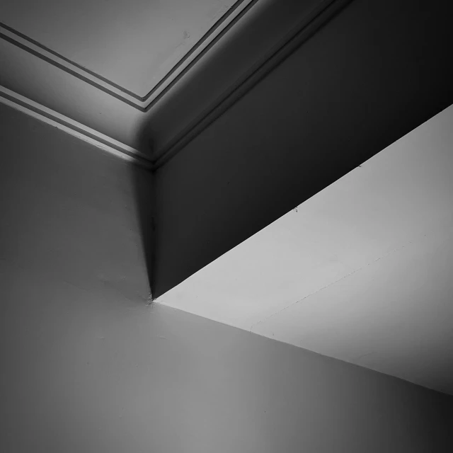 this is the corner of a ceiling where a window is visible