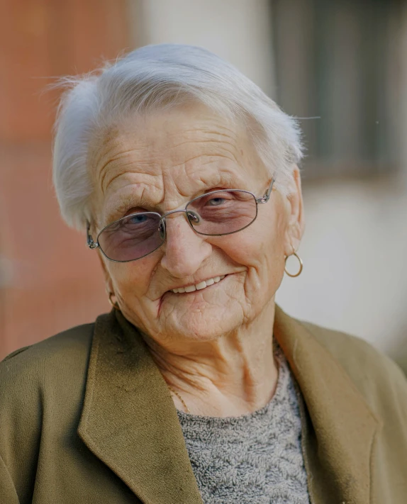 an older woman with glasses smiling for the camera