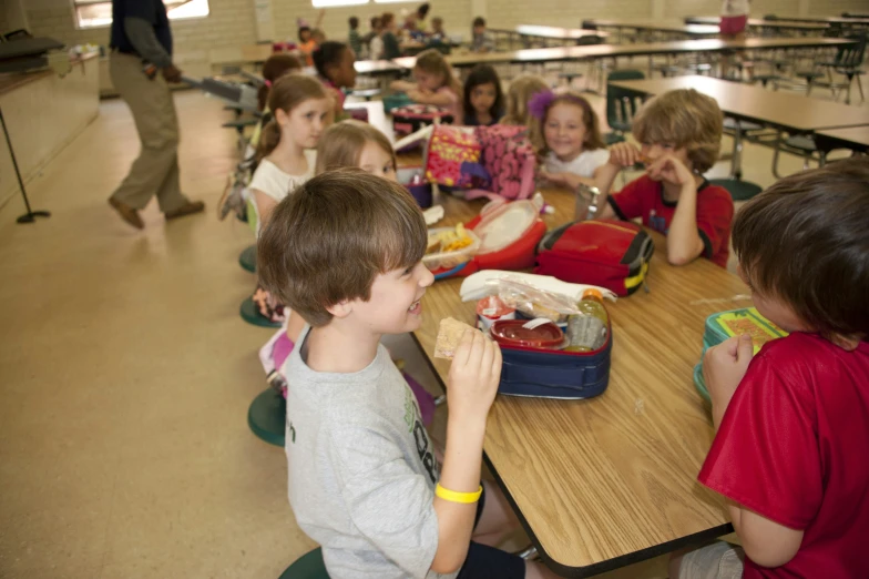 children in a classroom eating lunches and other things