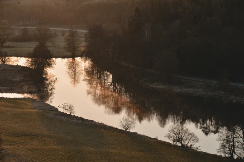 the reflection of trees on the water has been partially visible