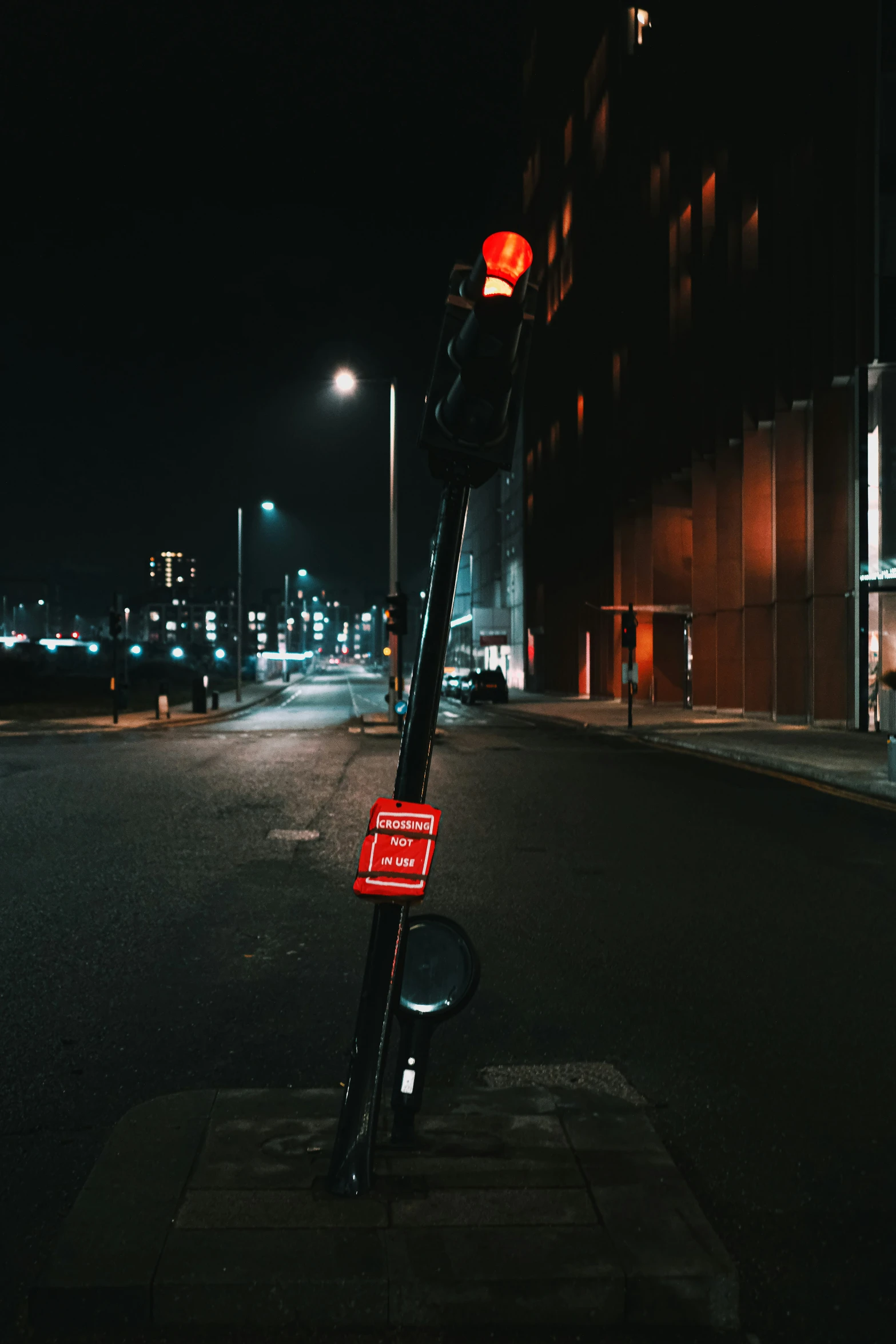 a city street at night with an overhead traffic signal