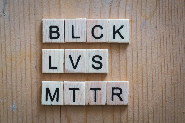 wooden blocks spelling block lives mitr on top of a wooden surface