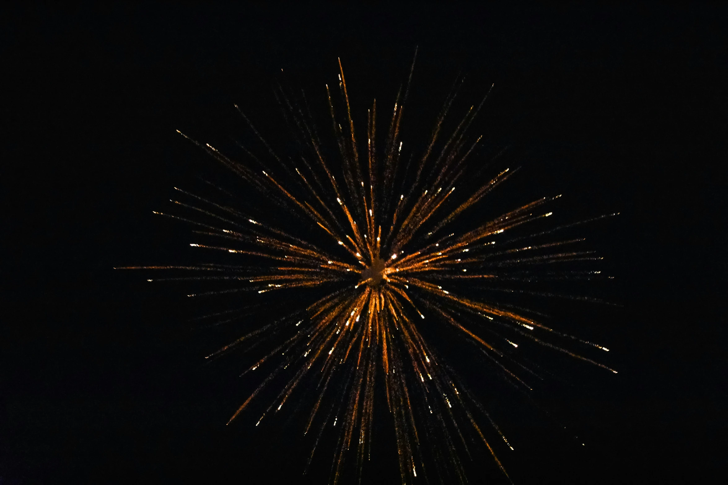 a big clock tower with firework on it's sides