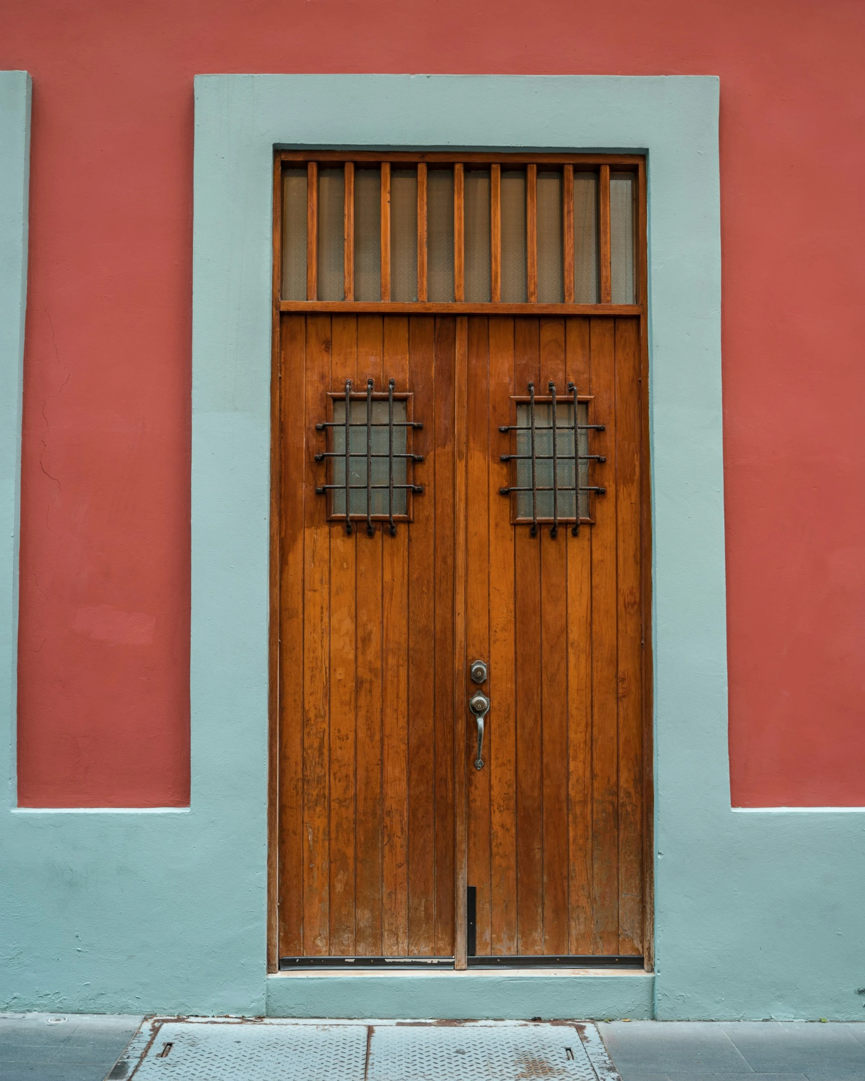 two large doors in front of a red building