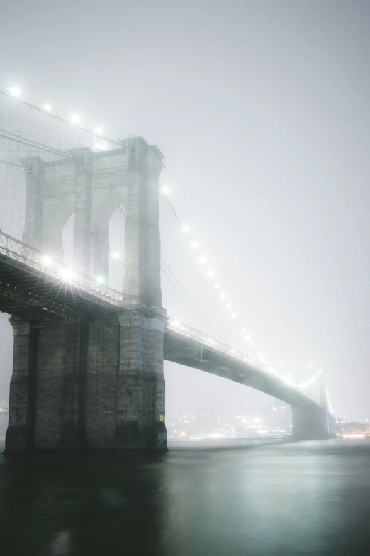 a bridge and fog with the lights on