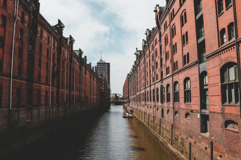 a small canal in a brick area lined with buildings