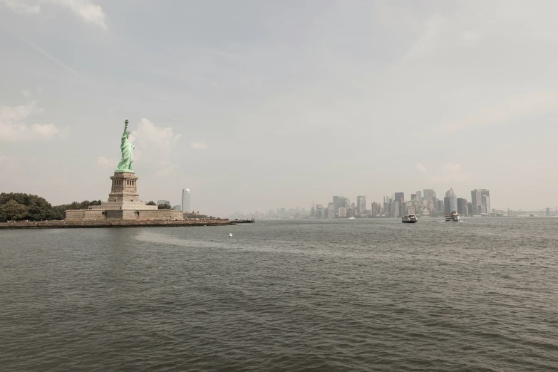 an island with a large statue of liberty at its center