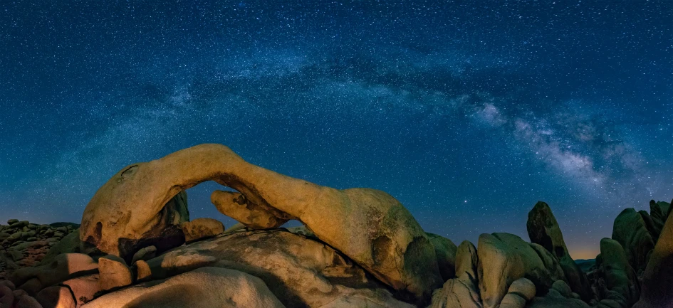 an arch and milky over rock formations