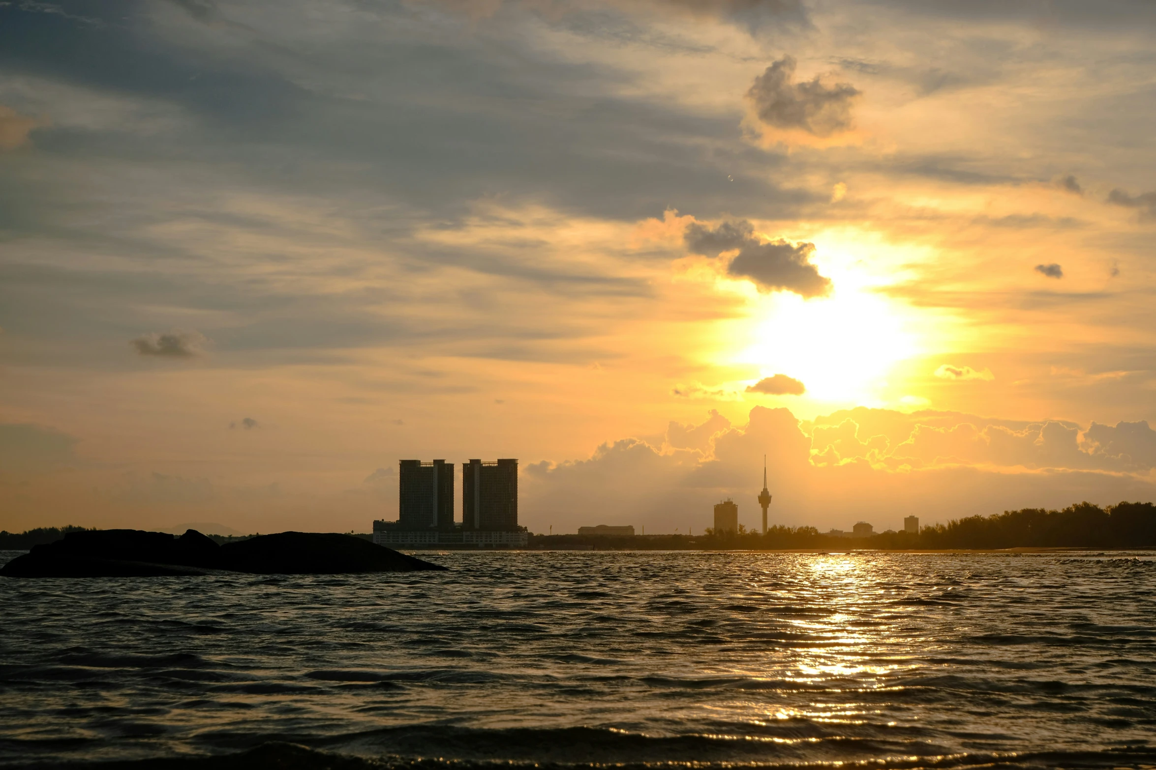 a body of water with buildings in the background