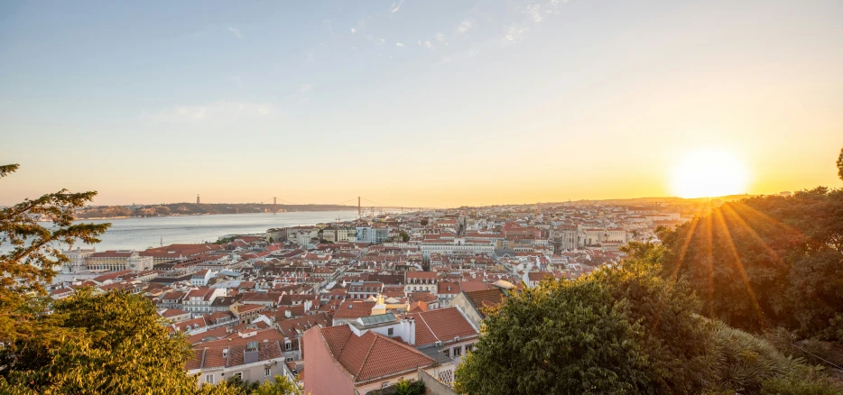 the sunset over the rooftops of a city