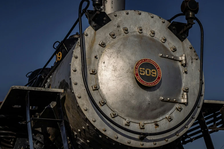 a large metallic train engine with black trim