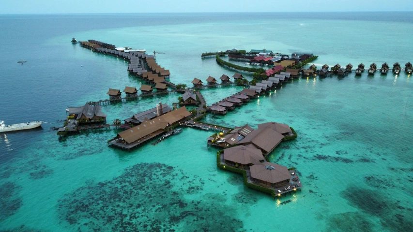 an aerial view of an island near a ship