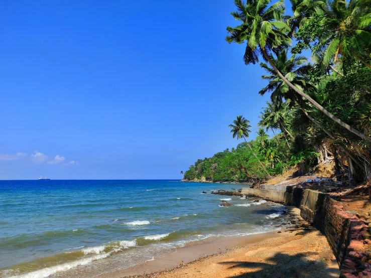 an empty beach sits alongside the ocean