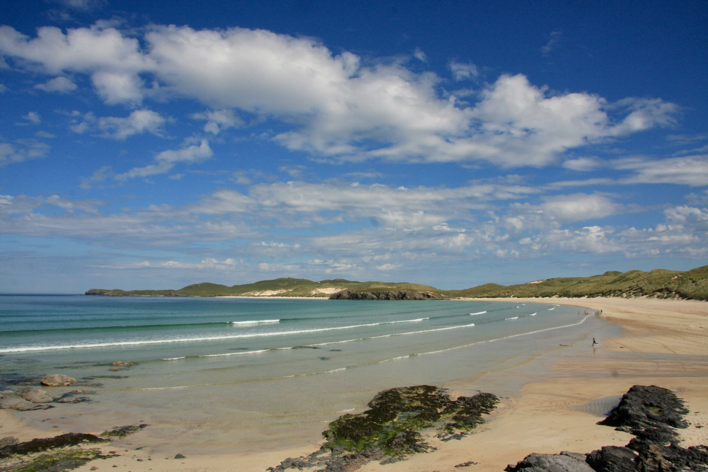 a blue sky with clouds above the ocean