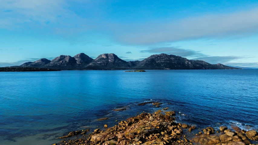 a body of water that has some mountains in the background