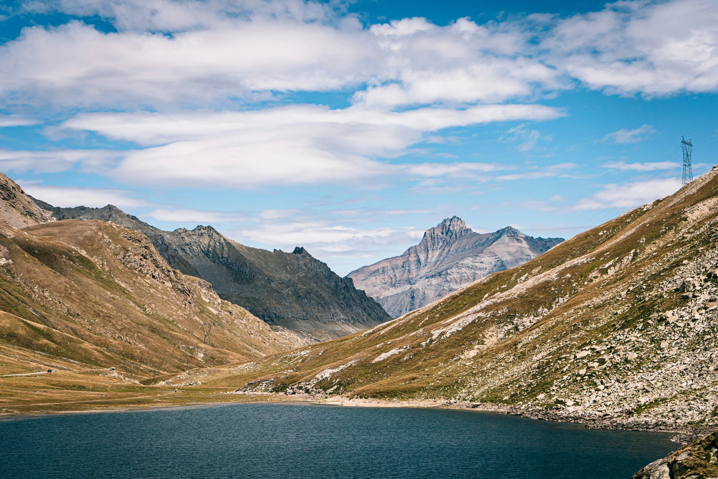 a scenic view of water in front of mountains