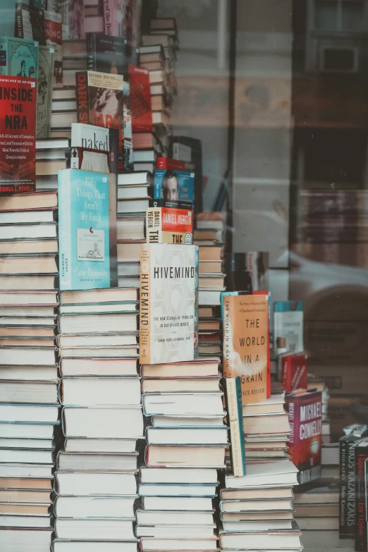 several books are stacked on the window