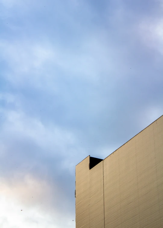 a building and a clock tower are silhouetted against the sky