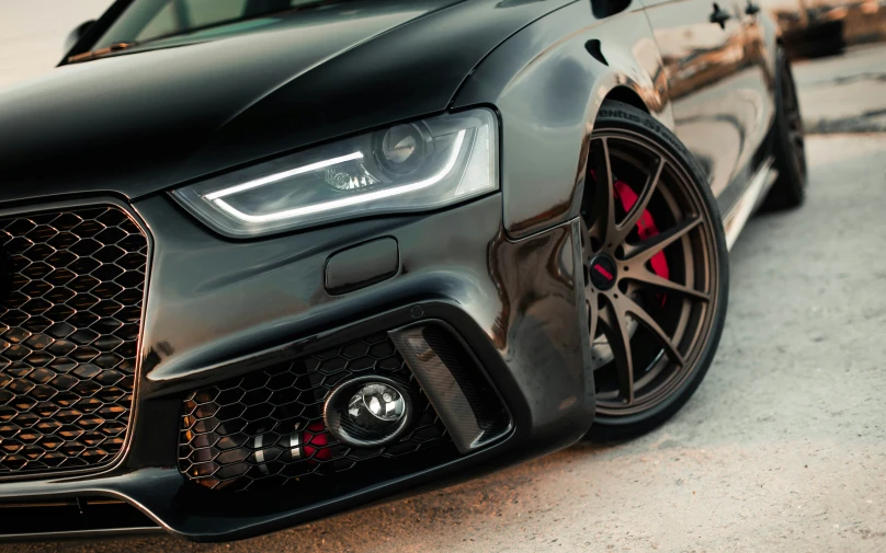 a silver and black audi is parked on the street