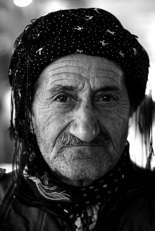 a man wearing a hat and scarf poses for a po