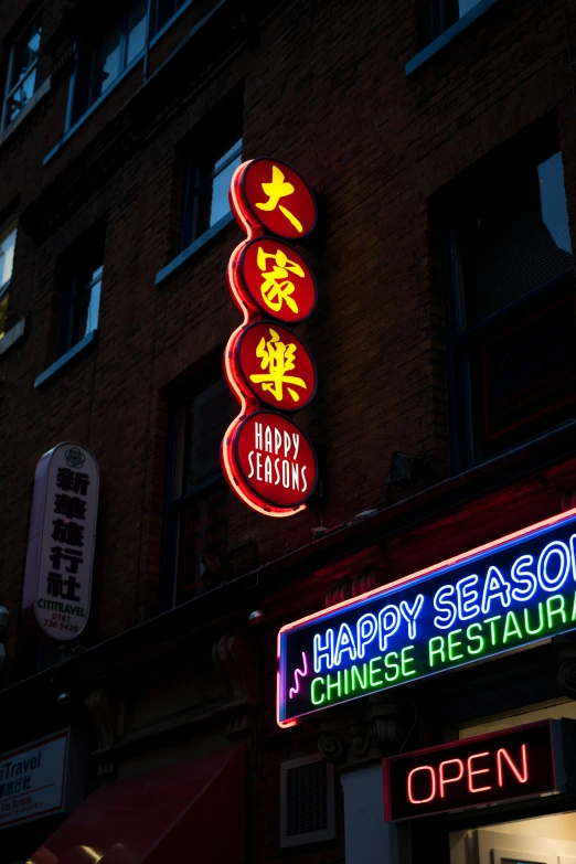 a neon sign advertising a chinese restaurant and happy season