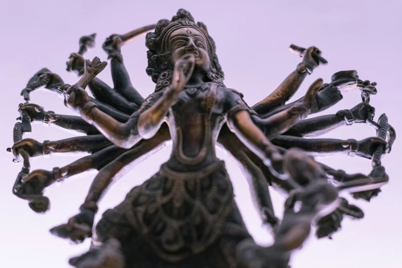 a statue made with several hands reaching toward the sky