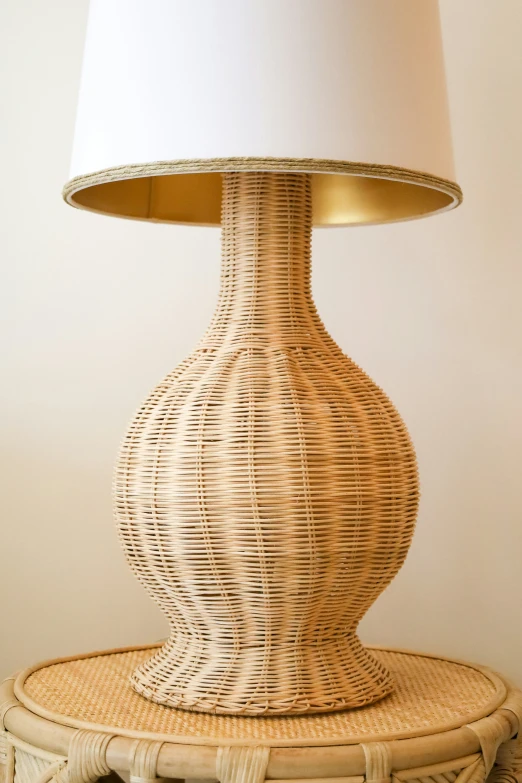 a lamp that is on a basket sitting on a table