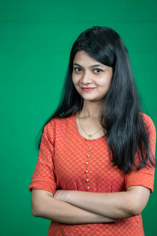 a woman posing with her arms crossed, smiling