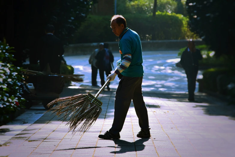 a man holding a broom in his hand