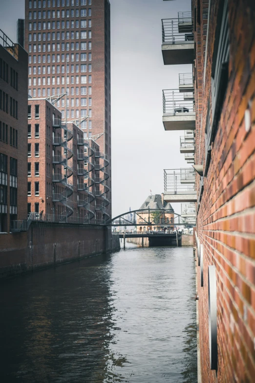 a bridge is in the water between two buildings